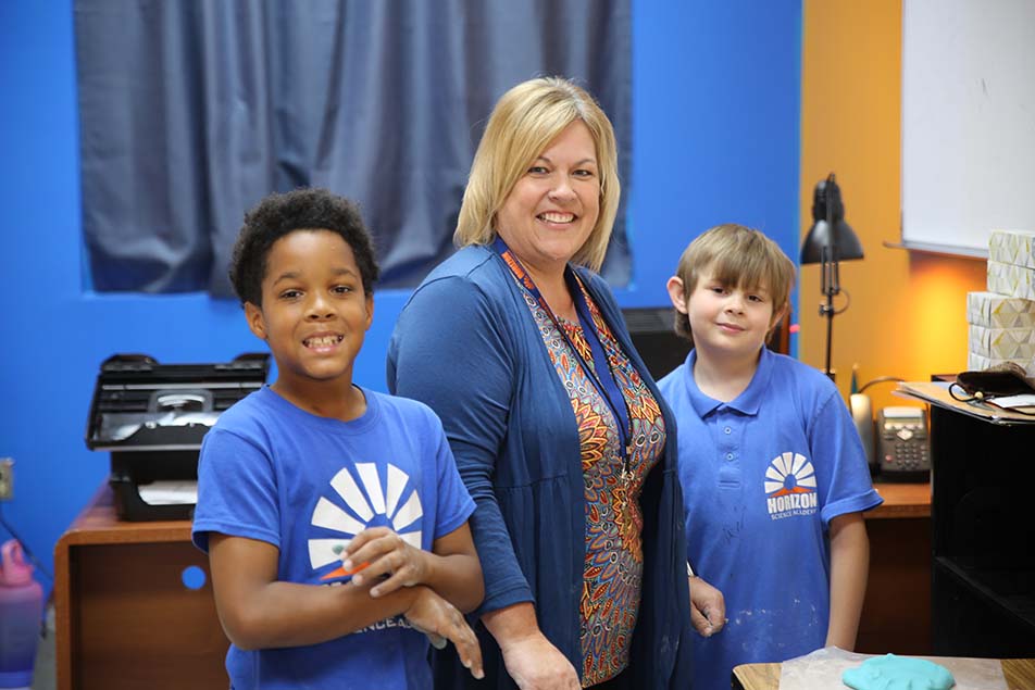 students and teacher working in classroom