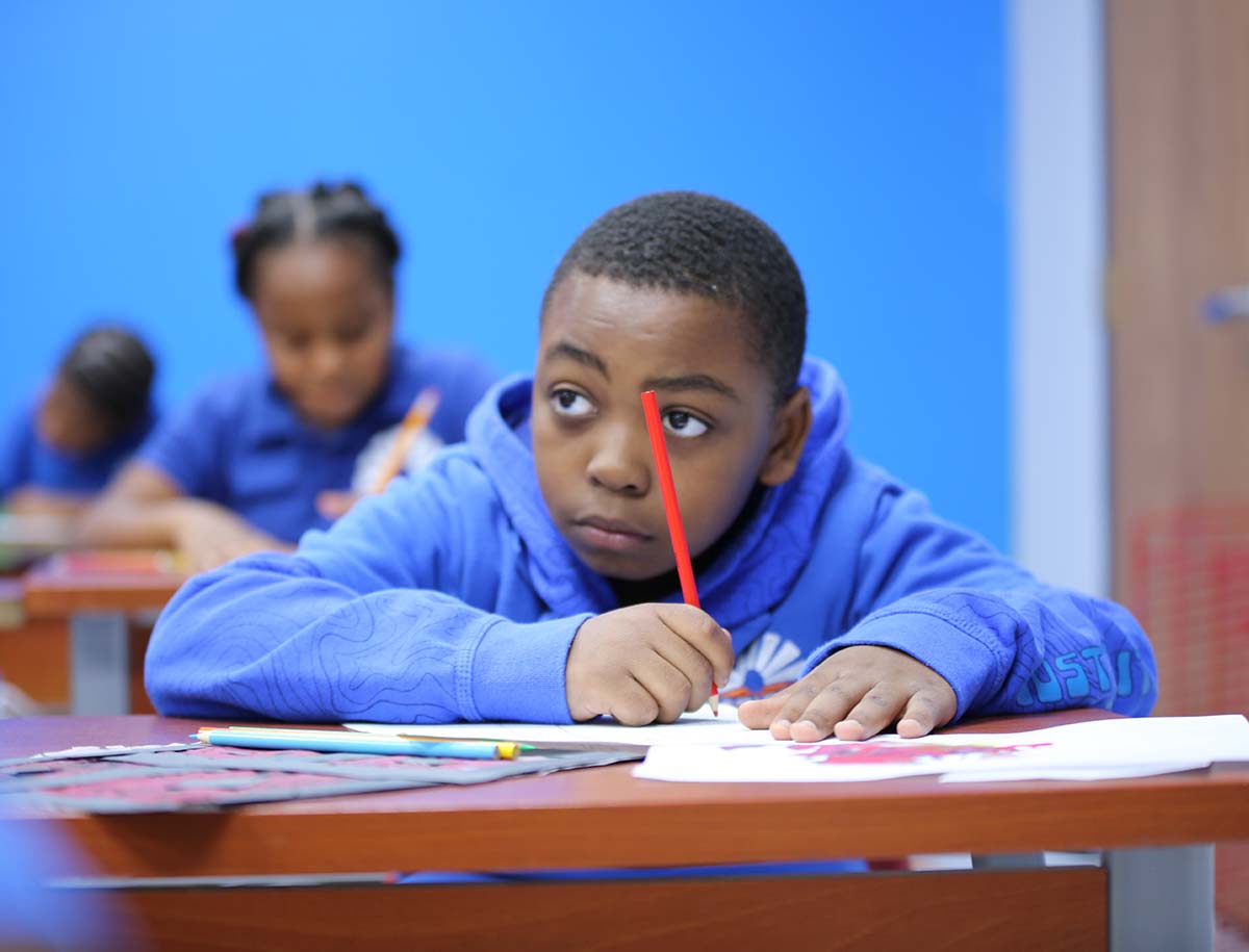 Horizon Science Academy Dayton Elementary student wearing headphones uses a laptop in class