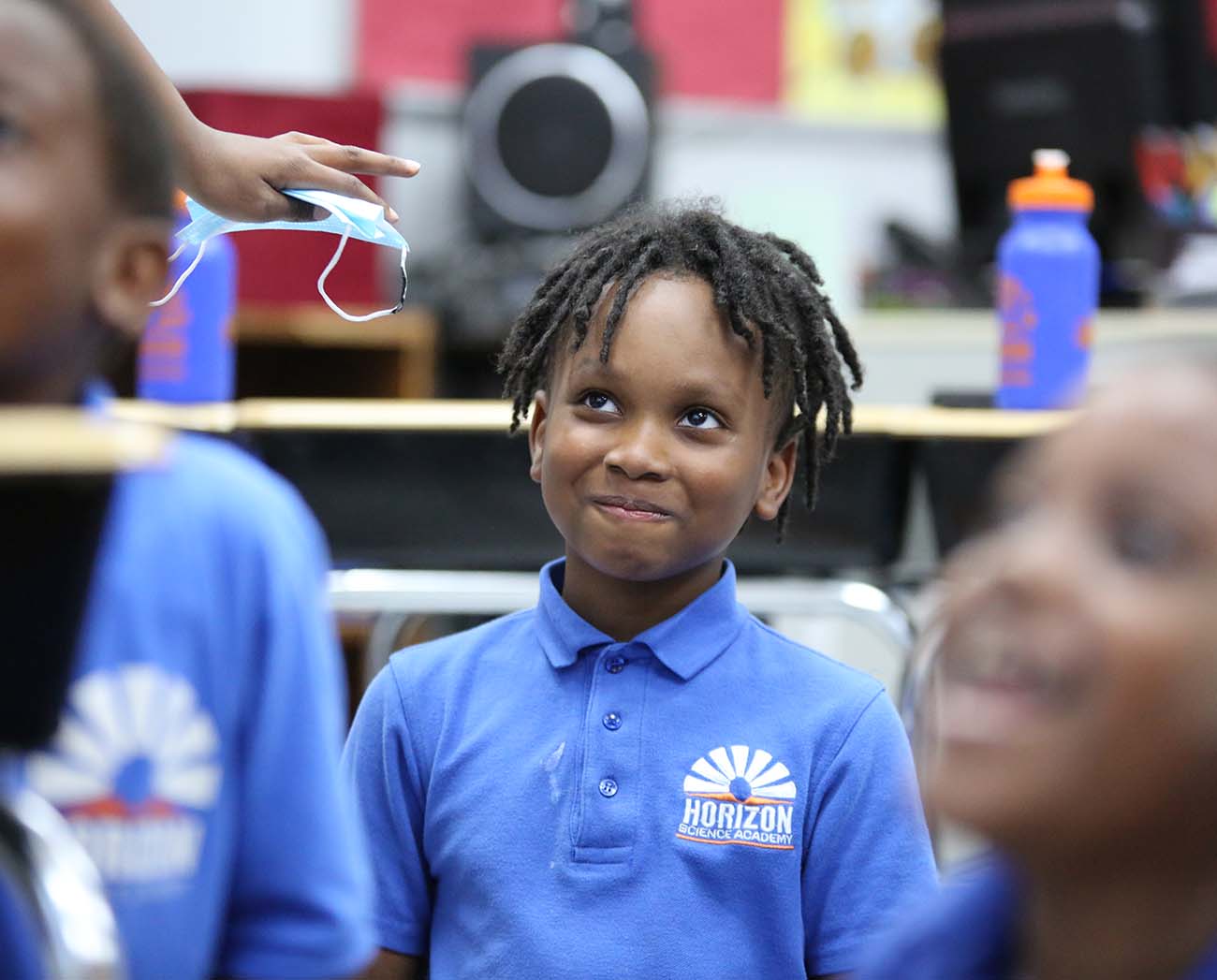 Smiling children together outdoors.
